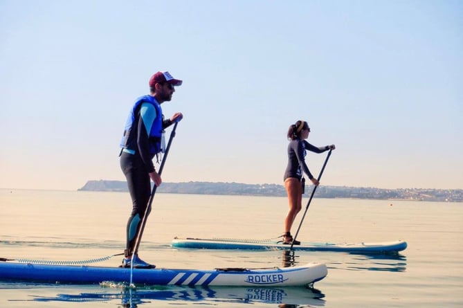 Rob and sister Carrie atop their paddleboards