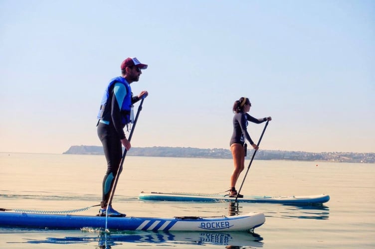 Rob and sister Carrie atop their paddleboards