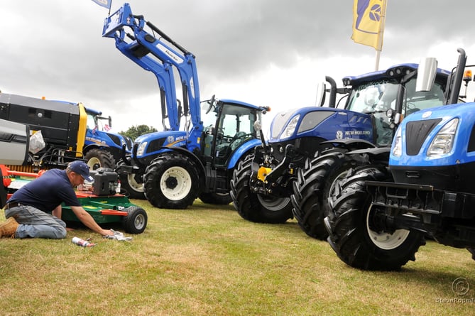 Photo: Steve Pope. MDA290622A_SP024
Devon County Show.  A final spit and polish for farming machinery before the gates open
