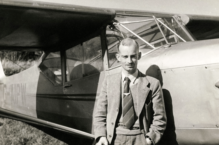 Harold Wingham standing beside an Auster 5J-160 light aircraft built in 1946.