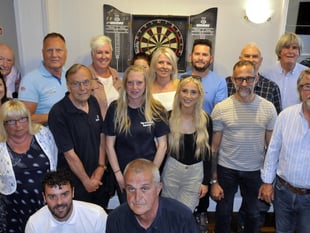 Charity darts team is thrilled to raise £1,000