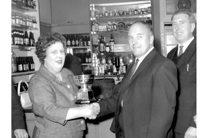 A 1965 Euchre team receiving the winners trophy in the lounge