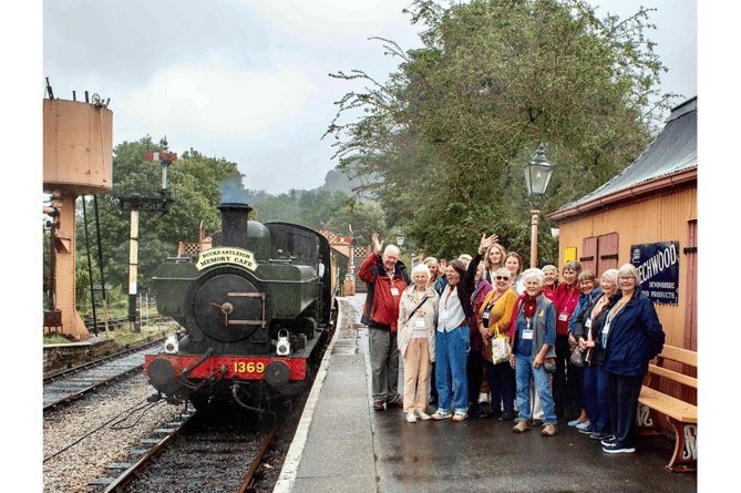 Passengers of the new mobile memory cafe at Buckfastleigh prepare to board