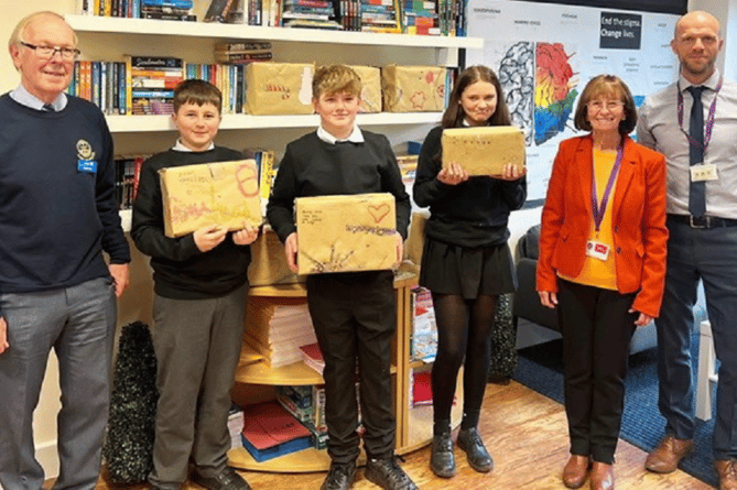 Students from Chances School, a vocational school in Dawlish, with their own-design Christmas shoeboxes, together with Dawlish Water Rotary Club president Chris May (left) and community governor Mary May and  head teacher Gary Hayes on the right.
