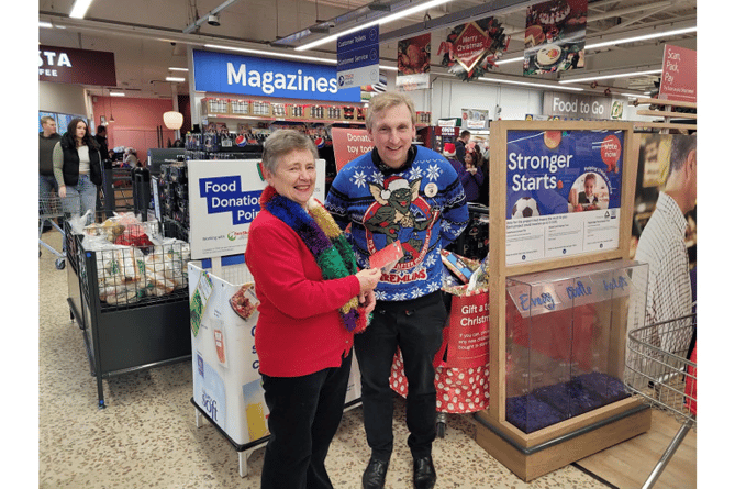 Susan is pictured receiving her prize from Tesco Kingsteignton Superstore manager Stuart Bennet.