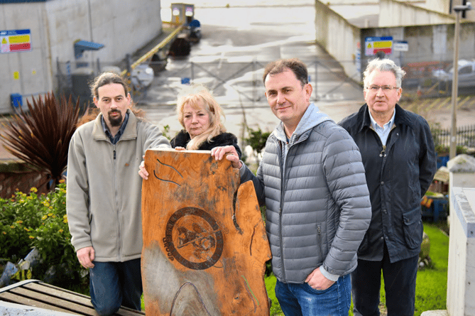 From left: Dan Comer, Penny Lloyd Mike Jackman and David Cox with the damaged table