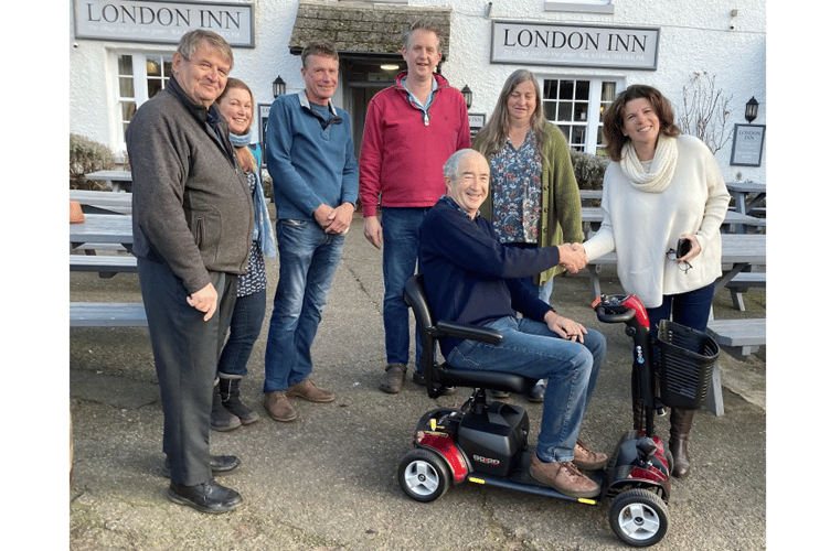 Councillors Chris Clarance, Lucy Bufton, Andy Burnham, Tim Palmer, Claire Stoyle and Danielle Westlake and Teignmouth Shopmobility trustee Brian Hamblin on the scooter