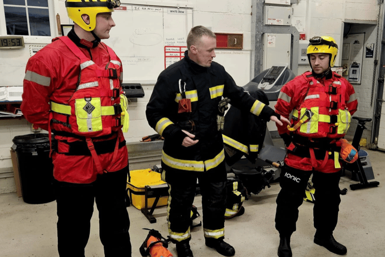 Firefighters don wading suits for water rescue training session