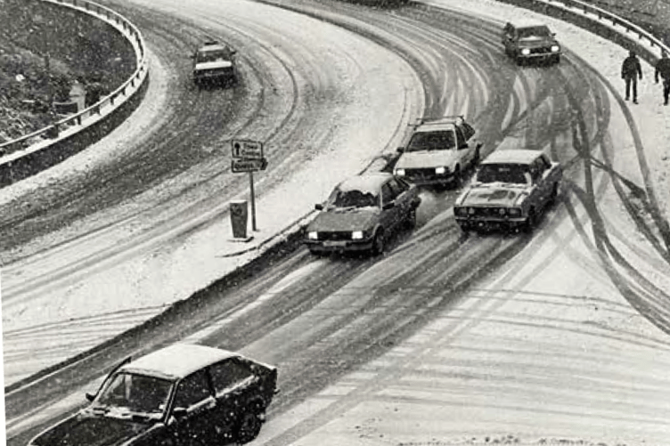 Traffic edges its way down the snowy slopes of Exeter Road in Teignmouth.