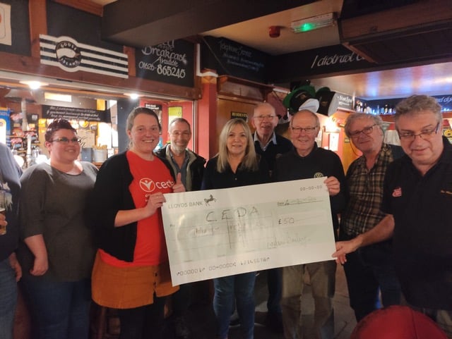 Quiz team from the Marine Tavern in Dawlish receive their prize from the Rotary Quiz