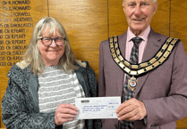Seventh stint as mayor for councillor as cheque handed to charity 