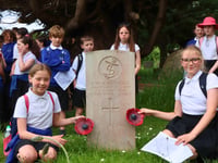 Children pay respects at war graves on D-Day anniversary 
