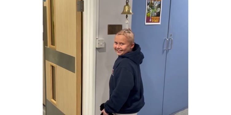 Francesca Walder ringing the bell at the end of her cancer treatment