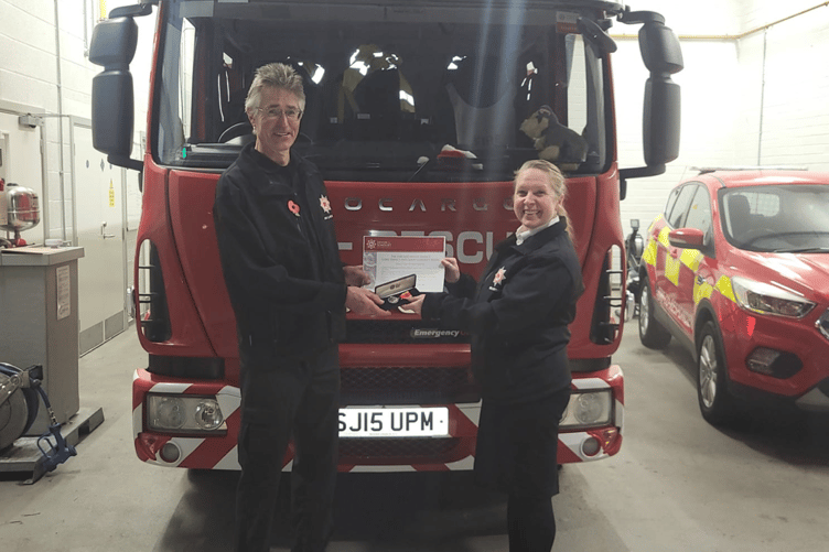 Assistant Chief Fire Officer Nicola Bottomley presenting firefighter Paul Bartlett with his 20 year long service and good conduct medal
