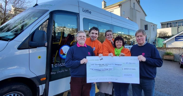 Pictured left and right are members of HGRFC Chris Cole and Martin Parsons with, centre Dawlish Community Transport team members Rowan Ford, Fritha Langdell and Sally Preston.