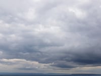 Partly cloudy and breezy turning sunny later