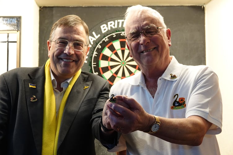 Richard Hayward, right, shows the 2025 badge to MP Martin Wrigley. Photo Bob Simpson