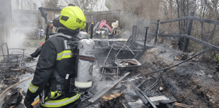 Garden ravaged by fire as crews save house 