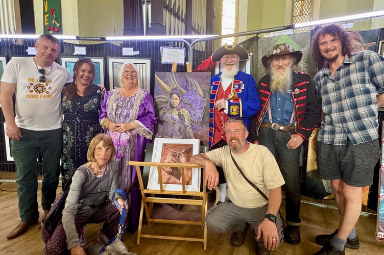 Luke Steffens at his exhibition with dad Brian, wife Caz, fellow artists and Dawlish Town Crier Bob Graham and his wife Heather. PHOTO BOB SIMPSON 