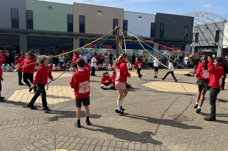 Wolborough School pupils dance around the May Pole in the Market Square, Newton Abbot. 