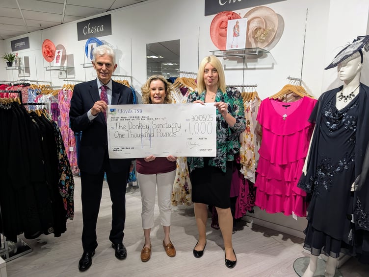 David Austin, Nicola Ireland and Christine Llewellyn with the proceeds of a fashion show being handed to the Donkey Sanctuary.