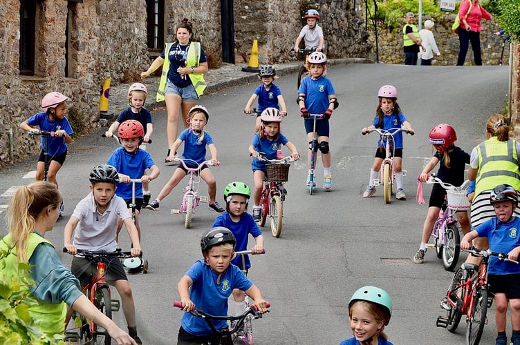 Children from Abbotskerswell Primary School join the dads as they finish their cycle ride.