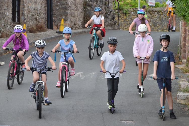 Youngsters from Abbotskerswell Primary School scooted and cycled to welcome the fund-raisers home.