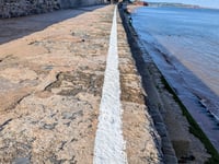 Rail company paints 'experimental' white safety line on sea wall 
