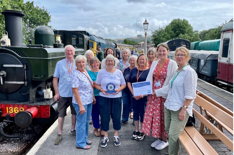 Volunteers celebrate Buckfastleigh Memory Cafe achieving the Quality Mark at South Devon Railway. 