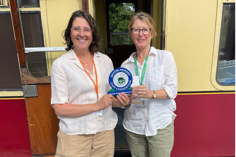 Left Kathrine Bailey, cafe founder and co-ordinator receives the award from Elaine Musgrave, from Teignbridge CVS.