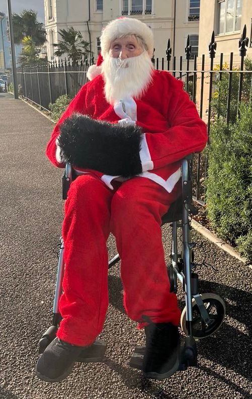 Joan Aplin dressed as Father Christmas.