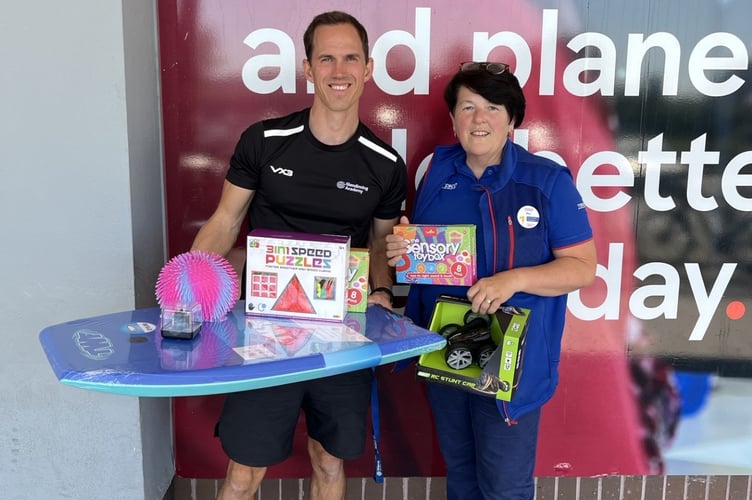 Simon Gibbs, vice principal at Glendinning Academy, receives prizes donated by Bev Perrins, Newton Abbot Tesco Superstore’s Community Champion.
