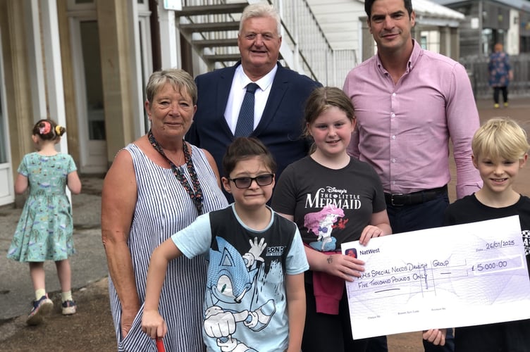 Claire Coombs, Team leader AIMS, with Paul Beatty, Charity Steward St Michaels Lodge Dawlish, and Alex Pemberton, Master of St Michael's Lodge with some of the children who wil benefit from the donation 