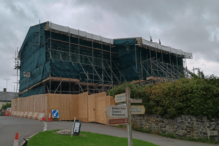 The scaffolding covering the thatched cottages at Drewsteignton which are due to be rebuilt after a fire