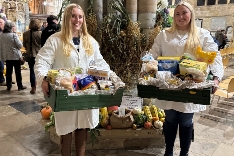 The South Devon Group representatives with cereals they donated to Exeter Food Action and in front of their decorated pillar.  AQ 6696