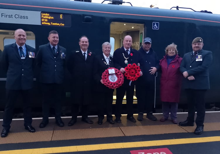 The Dawlish poppy wreath being handed to GWR staff. Photo Noreen Goodchild