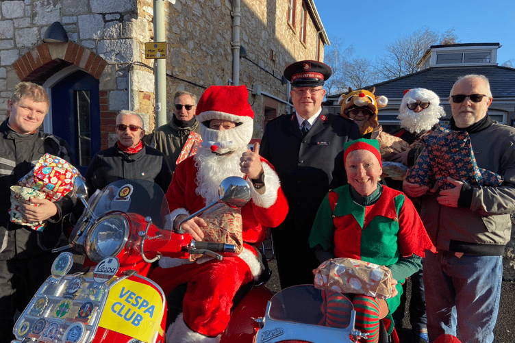 Father Christmas swapped his sleigh for the Italian classic Vespa scooter when he came to drop off presents at Newton Abbot's Salvation Army
