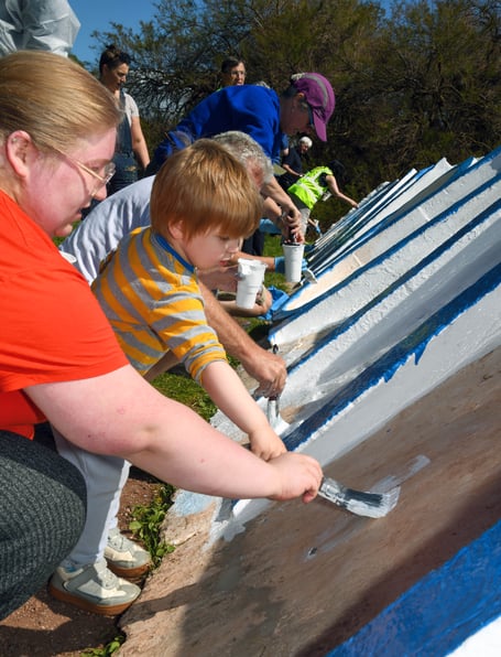 Volunteers paint the Teignmouth Letters. Photo David Caunter 