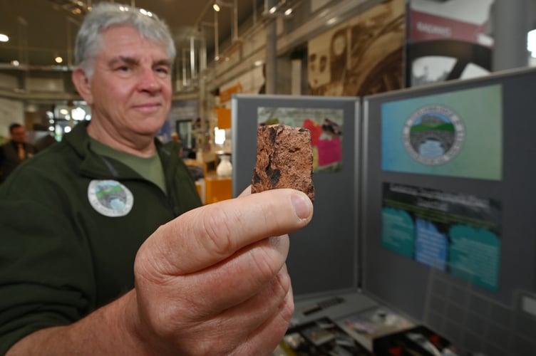 Teignbridge Archaeological Society archaeology fair at Newton Abbot Town Hall. TS member Clive Hammett  and a Roman coin die stamp found near the Newton Abbot to Totnes Road