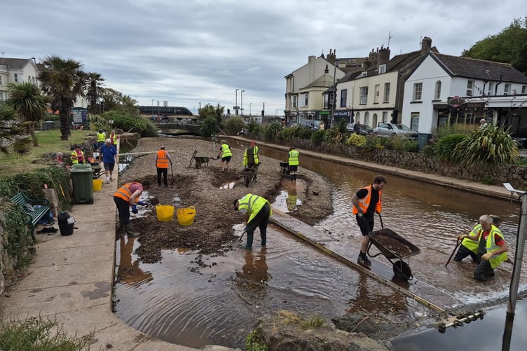 Volunteers clearing the sediment from the Brook boating lake in Dawlish. Photo WADE