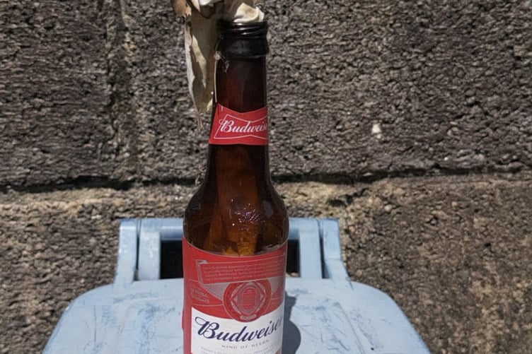 Improvised 'petrol bomb' bottle, found in a garden near the Teignmouth arson attack