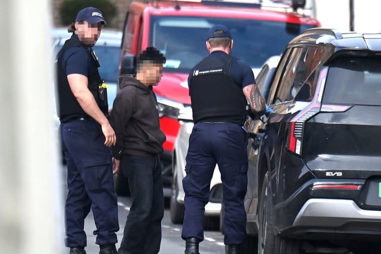Immigration Enforcement officers detain a suspect in Union Street, Newton Abbot